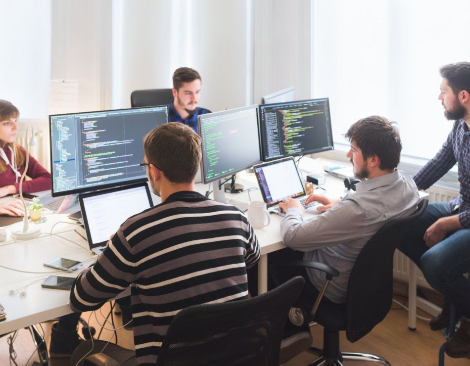 The cyber security team working together in the office